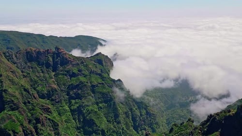 Drone Rugged Mountain Peaks with Vegetation Landscape Covered Beautiful Clouds