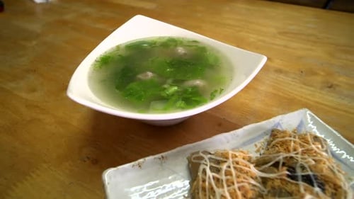 Asian soup and pancake dish on a table