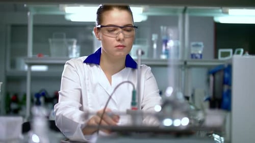 Focused Woman Working in Bright Scientific Laboratory