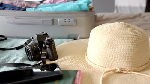 Essential Travel Items and Packed Suitcase Ready for Vacation