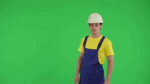 Medium Green Screen Isolated Chroma Key Video of a Young Construction Worker Looking to the Side of