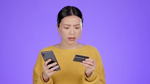 Upset, phone and shocked woman with credit card problem in studio isolated on purple background