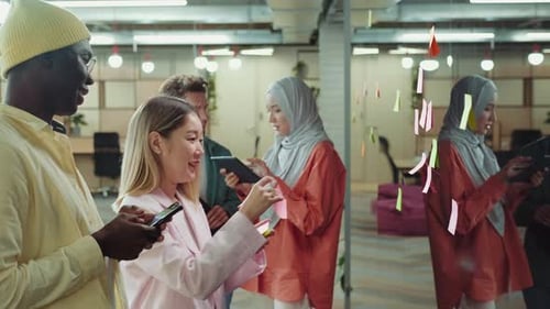 Diverse Team Collaborating on Sticky Note Project