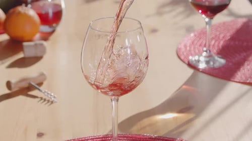 Pouring Red Wine into Elegant Glass