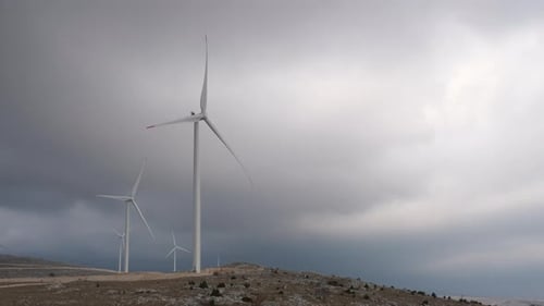 A large wind turbine plant. Sustainable and renewable green energy from the wind. Turbines arranged
