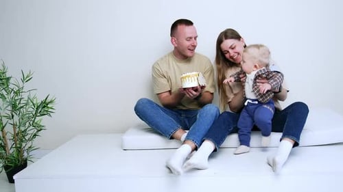 Happy Family Celebrates Baby's Birthday with Cake