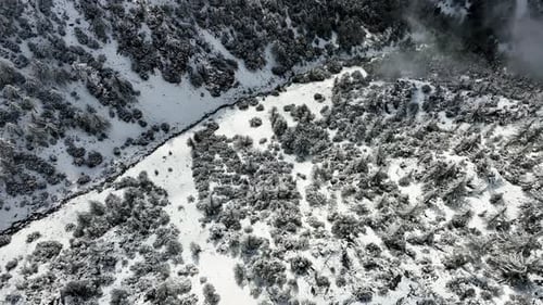 Aerial View of Snow-Covered Mountain Valley in Winter