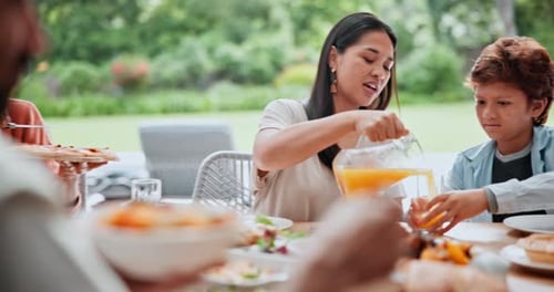 Diverse Family Enjoys Meal Together Outdoors