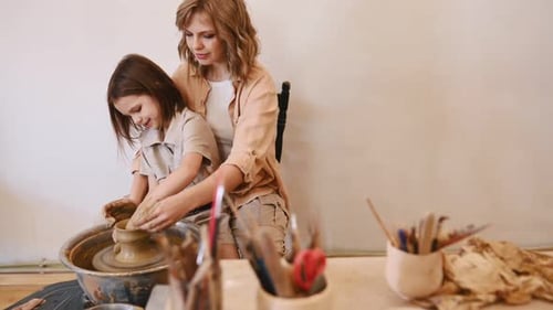 Woman and Girl Creating Pottery Together