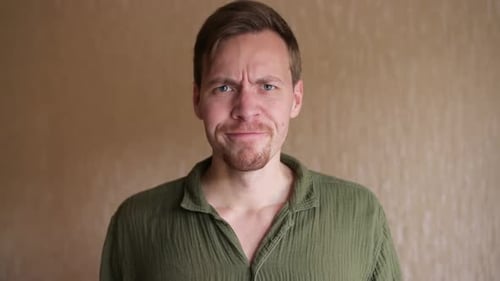 Upset Man Looking Directly at Camera
