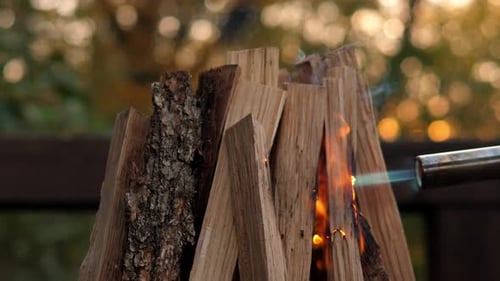 Firewood Ignites with Blue Flame Outdoors