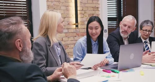 Business People Discussing Documents in Meeting