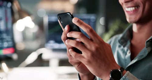 Young Adult Uses Smartphone in Modern Office