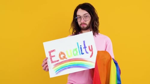 Attractive Bearded Gay Caucasian Man Holding a Protest Sign During a LGBT Pride Parade