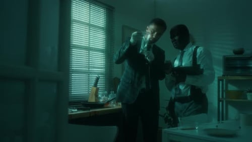 Detectives Investigating Crime Scene in Dark Kitchen