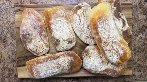 Rustic Wood Cutting Board Displaying Fresh Bread Loaves