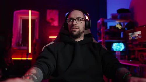 Enthusiastic Young Adult Gaming at Neon Lit Desk