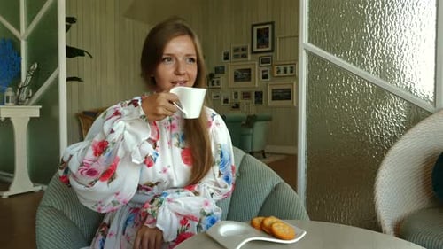 Woman Sips Tea in Sunny Room