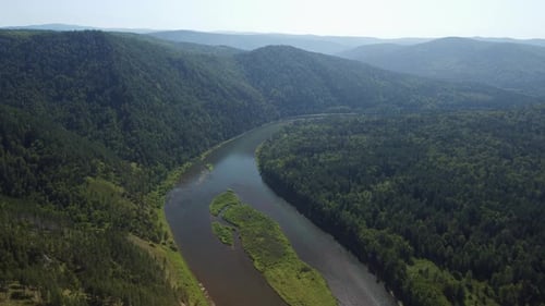 Awesome aerial view of scenic river among evergreen woods