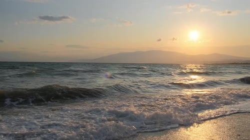 Sunrise on the beach. Sea. Sunlight and sun ray reflect on water surface