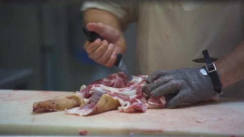 In the Meat Shop a Worker Professionally Separates the Bone From the Meat