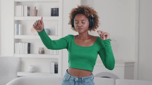 Woman with Headphones Dancing and Enjoying Music