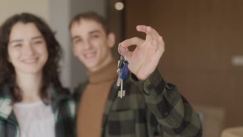 Happy Couple Holding Keys to New Home