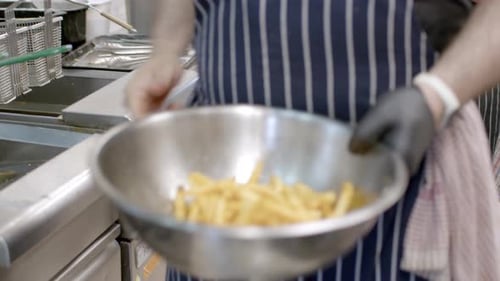Chef Prepares Delicious French Fries in Restaurant Kitchen