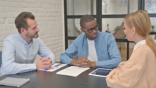 Mixed Race Entrepreneurs Discussing Work in Office