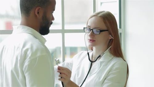 Doctor with Stethoscope Examines Patient in Clinic