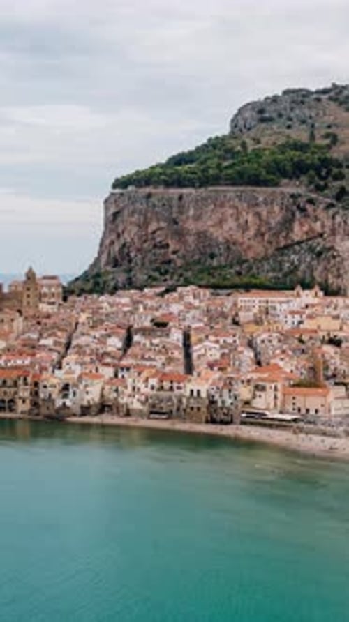 Vertical drone Hyperlapse of Cefalu. Ancient Italian town along the Mediterranean sea coast of Sicil