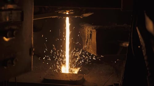 Steelmaking Metal Remelting View of Pouring Hot Liquid Metal Glowing Flame in a Furnace Heavy
