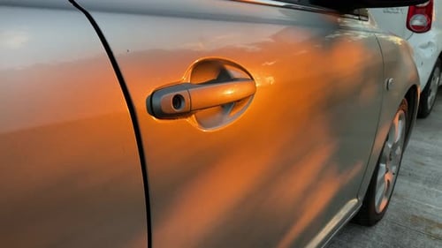 golden hour the sun shines beautiful golden colour of the door of a car