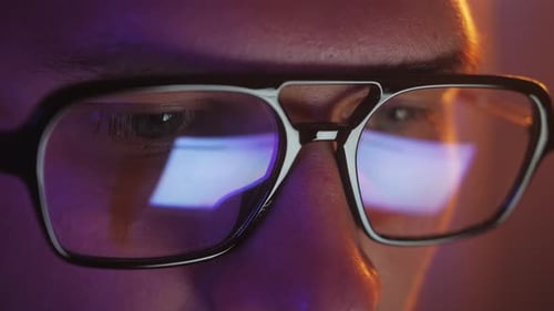 Close-up of Young Adult Wearing Glasses at Night