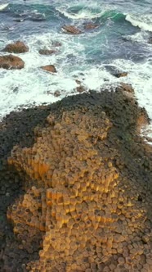 Social ratio aerial video of the stones at The Giant's Causeway in Bushmills, Northern Ireland