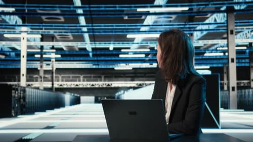 Typing on Keyboard Laptop and Engineer in Data Center