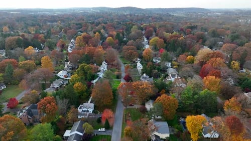New England town in autumn. Residential community in American suburbs. Fall leaves and colorful foli