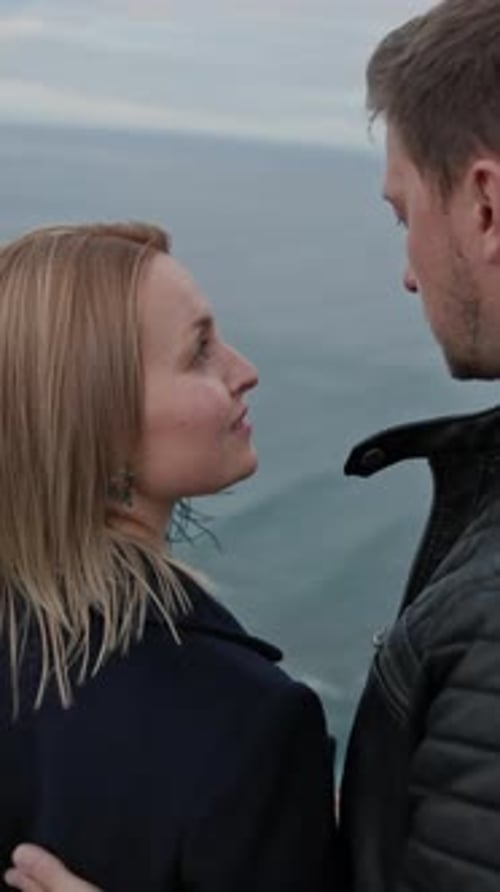 Romantic Couple Embracing on a Cliff Overlooking the Ocean