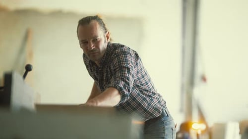 Concentrated Craftsman Using Paper Cutting Machine