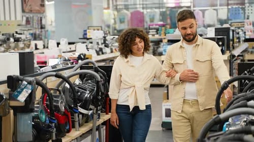 Couple Choosing Vacuum Cleaner in Electronics Store