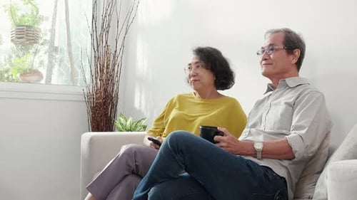 Elderly Couple Watching TV and Relaxing at Home