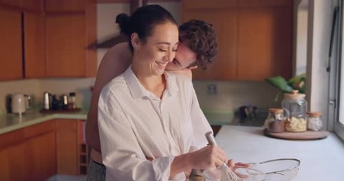 Affectionate Couple Baking Together in Bright Kitchen
