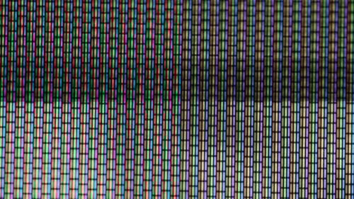 Close-Up Of CRT TV Screen With Distorted Video And Static Noise
