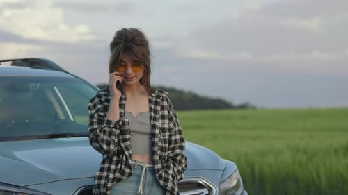 Woman Talking on Mobile While Standing Among Field