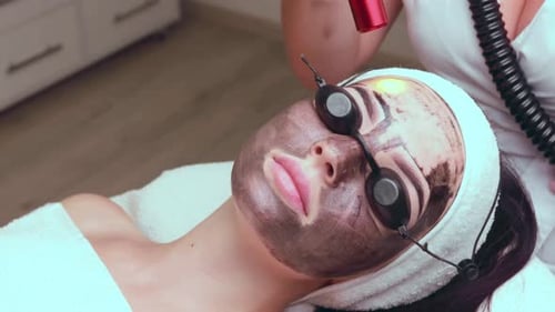 Woman Receiving Laser Treatment at Beauty Salon