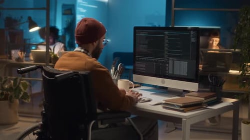 Anonymous Male IT Guy Living with Disability Working at Office Desk