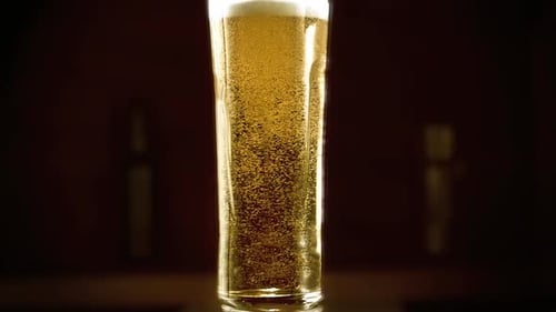 Microbrewery Close-up. Slow-motion Cold Light Craft Beer in a glass.