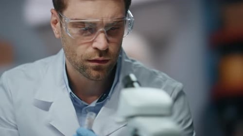 Busy Doctor Working Laboratory Looking in Microscope Close Up Serious Scientist