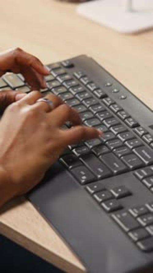 Vertical Video Person at Home Office Desk Typing on PC Keyboard Next to Coffee Mug Close Up