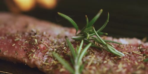 Steak cooking on the grill on fire